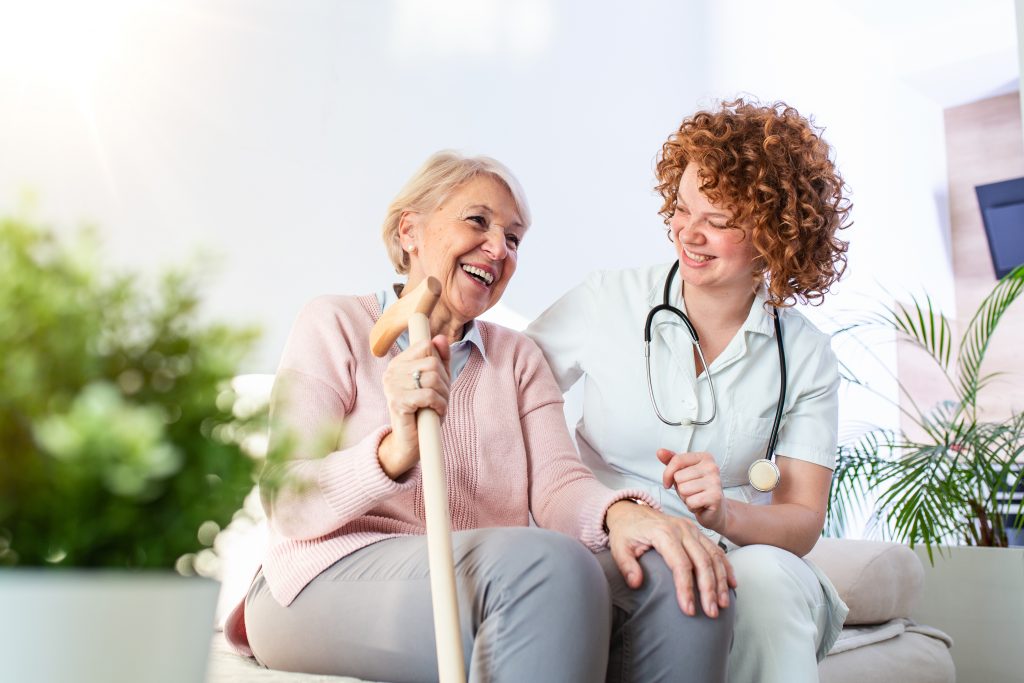 a healthcare professional talking with a happy elderly person